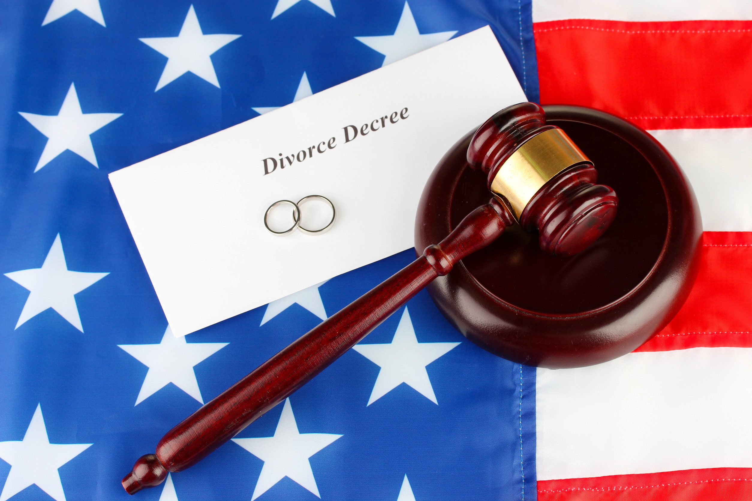 Divorce decree and wooden gavel on american flag background