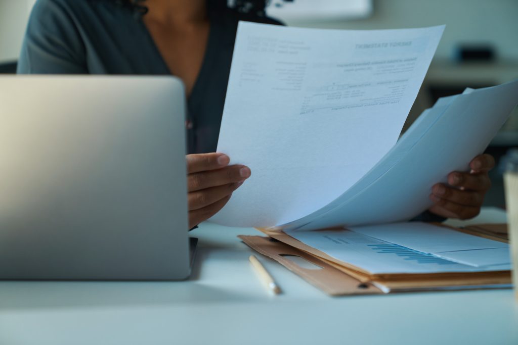 African american woman sitting at the table and studying documents
